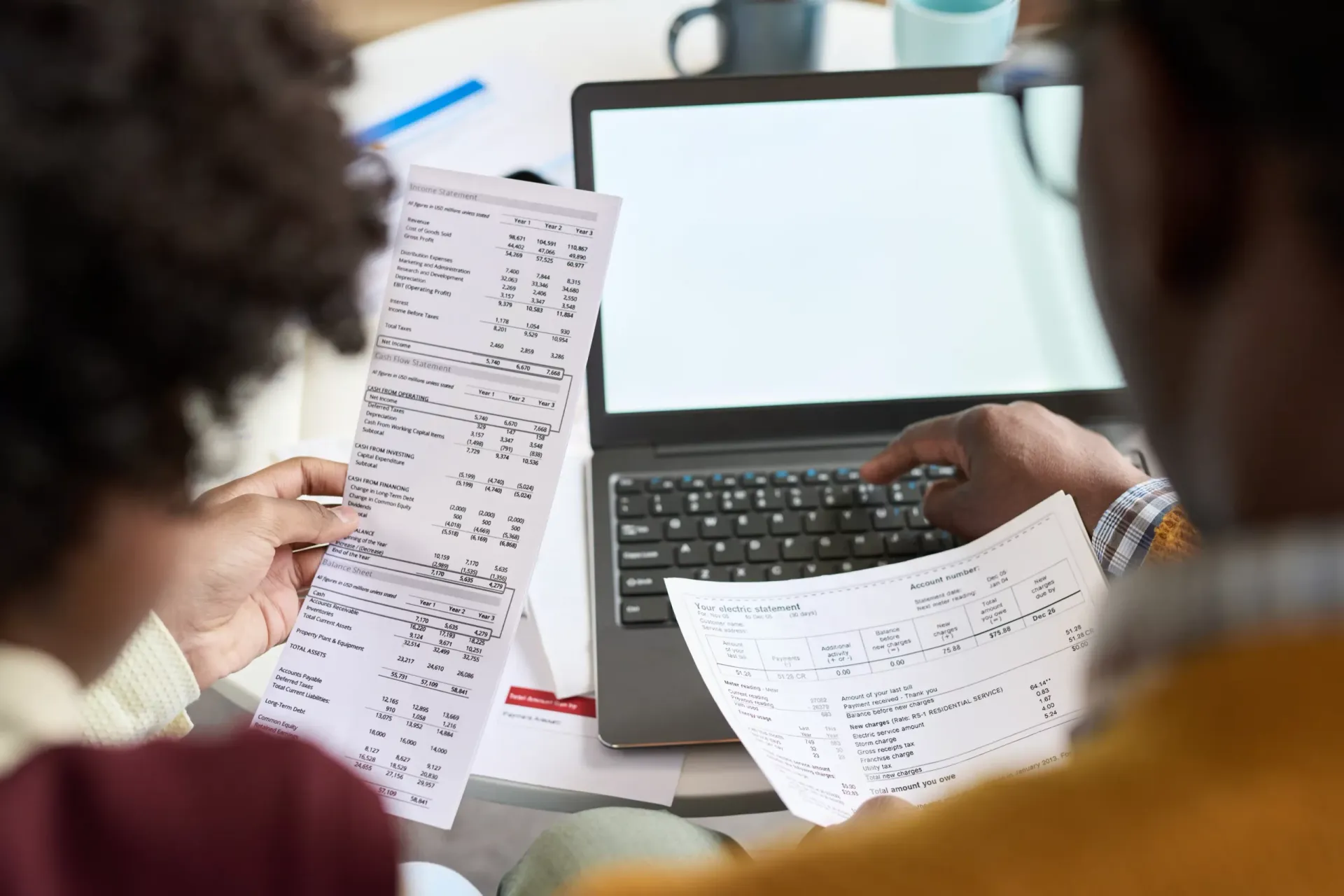 Chartered accountant examining Singapore Financial Reporting Standards statements and XBRL conversion data